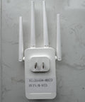 Fast WiFi Extender AC1200Mbps Dual Band 5.8GHz And 2.4GHz With Four Antennas on white wall surface