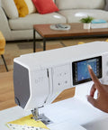 Heavy Duty Computerized Sewing Machine With Sharp LCD Screen Quilting Kit Extension Table And Bonus Bundle Making Homemade Creations, user accessing LCD screen.