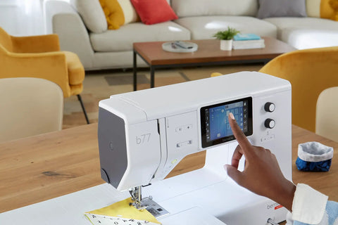 Heavy Duty Computerized Sewing Machine With Sharp LCD Screen Quilting Kit Extension Table And Bonus Bundle Making Homemade Creations, user accessing LCD screen.