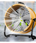 Heavy Duty Industrial Floor Drum Fan Rock Solid Steel Frame Kickin High Speed Airflow For Garage Workshop Jobsite And Warehouse Summer Cooling Operations in yellow with balanced blades and a sturdy base.