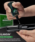 Applying CLP oil from 9mm Bore Cleaner And Pro Grade 5 Oz CLP Oil Gun Cleaning Kit to firearm slide with toolbox visible in background