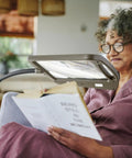 Woman reading under a Bronze Floor Magnifier Lamp With 8x10 Inch Shade 3x Magnification Built In LED Lighting Full Page View