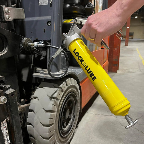 LockNLube premium yellow pistol-grip grease gun with 20-inch hose, used on forklift (side view)