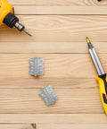 Self Closing Stainless Steel Spring Door Hinges With Screws on wooden surface with drill and screwdriver