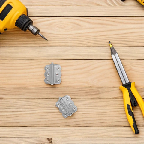 Self Closing Stainless Steel Spring Door Hinges With Screws on wooden surface with drill and screwdriver