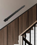 Heavy Duty Stainless Steel Wall Mount Handrail With Sick Grip For Stairs And Bathroom Walls mounted on a wall near wooden stairs.