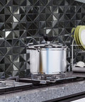Kitchen with stainless steel backsplash tiles peel and stick 10 sheets with 3D brushed windmill pattern in black, stove view.
