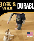 Child and dog on floor showcasing Super Hard Wood Wax For Ultra Durable Finish And Extra Lustrous Sheen That Builds On Super Duper Oil And Wood Butter Great For Lighter Woods Clear Wax Finish 9 Ounce Glass Jar effect, Made in USA label visible.