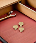 Antique Zinc Alloy Drawer Pulls for Dresser and Cabinets with floral design in gold finish, shown on a wooden surface.