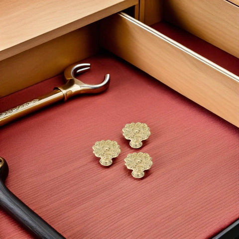 Antique Zinc Alloy Drawer Pulls for Dresser and Cabinets with floral design in gold finish, shown on a wooden surface.