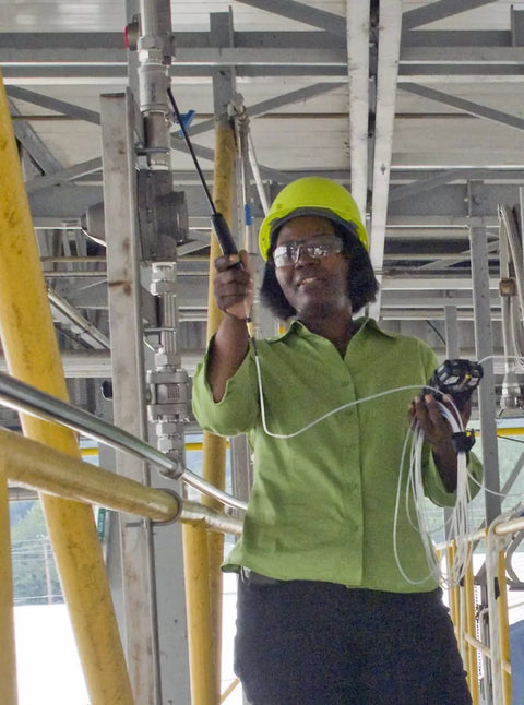 Sampling Line With Quick Disconnect For ALTAIR 5X Pump Probe in use by technician in field, showing portable gas monitor setup.