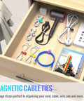 Magnetic Cable Ties 10 Pack Reusable Cable Organizers for Earbuds and Cords neatly arranged in a wooden drawer with other accessories.