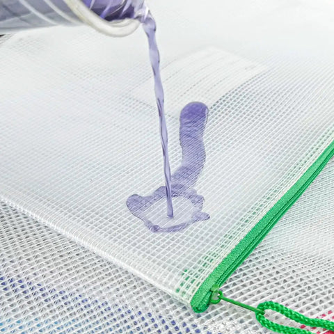 Close-up of a 24 Pack Small Mesh Zipper Pouches With Label Pocket Waterproof Bags, showing water resistance feature with liquid on surface.