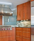 Modern kitchen with stainless steel appliances and wooden cabinets featuring 12mm Diameter Brushed Stainless Steel T Bar Cabinet Handles Hollow Pulls.
