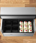 Rock Solid Double Sided Milk Cooler Built Tough For School Cafeterias Featuring Slick Sliding Doors And Premium Stainless Steel Construction Holding Up To Sixteen Crates For Seamless Everyday Kitchen Grind And Quick Cleanup with milk containers visible.