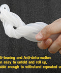 White silicone pressure tubing, 3/16 in ID, held in hand.