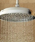Lambert 10 Inch Brass Rain Shower Head With 1.8 GPM Flow mounted on ceiling, streaming water, durable brass, premium finish resists corrosion