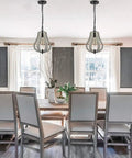 Dining room with two Vintage Wood Pendant Lights With Distressed White Finish, highlighting rustic swag style and metal wood construction.