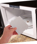 Hand holding Ten Pack Microwave Waveguide Cover Mica Sheets heat resistant insulation for microwave ovens replacement parts.