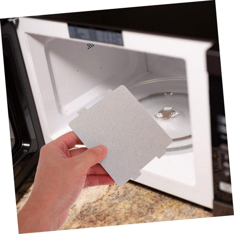 Hand holding Ten Pack Microwave Waveguide Cover Mica Sheets heat resistant insulation for microwave ovens replacement parts.