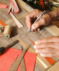Hand using 123 Piece Hobby Knife Set With 3 Carving Craft Knives And 120 Size 11 SK5 High Carbon Steel Blades Refills In A Safe Case