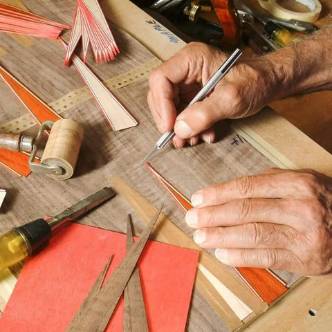 Hand using 123 Piece Hobby Knife Set With 3 Carving Craft Knives And 120 Size 11 SK5 High Carbon Steel Blades Refills In A Safe Case