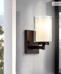 Pair Of Farmhouse Style Oil Rubbed Bronze Wall Sconces With Seeded Glass Shades on wall, featuring ambient lighting.