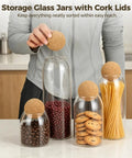 Straight Up Kitchen Essential Four Piece Glass Jar Collection With Airtight Spherical Cork Lids To Lock In Coffee Tea Candy Freshness And Effortlessly Organize Pantries No Fuss filled with beans and cookies.