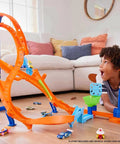 Child playing with Figure Eight Jump Track Set With 1 to 64 Scale Vehicle And Two Foot Tall Track That Connects To Other Sets.