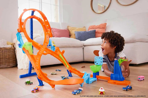 Child playing with Figure Eight Jump Track Set With 1 to 64 Scale Vehicle And Two Foot Tall Track That Connects To Other Sets.