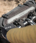 Cyclist with Front Loader 8L Waterproof Handlebar Bike Bag for Bikepacking, mounted on handlebars, rugged and weatherproof.