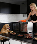 Heavy Duty Food Dehydrator With 650 Watt Motor And Eight Stainless Steel Trays featuring dried dog treats on countertop.