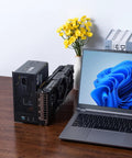 Absolute Beast Mini Egpu Enclosure With Forty Gbps Thunderbolt Three Four And Usb Four For Crisp Gaming And Smooth Ai Crunching Pcie External Dock next to a laptop on a table.