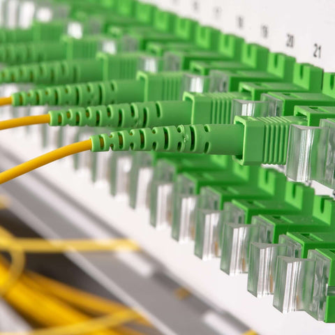 Close-up of fiber optic coupler FC to FC/APC square flange single mode simplex adapters used for fast network, telecom connectivity.
