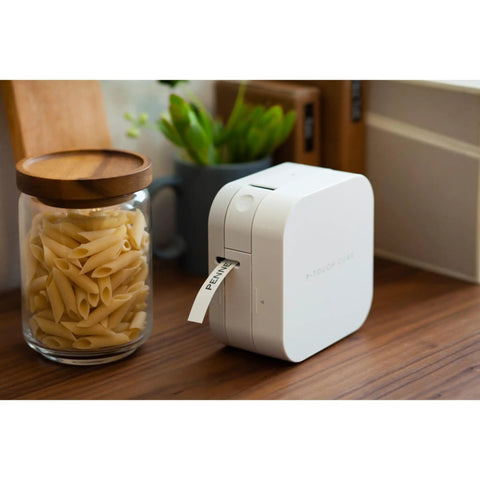 Total Game Changing Smartphone Color Label Maker Featuring Bluetooth Wireless Sync prints a label in a cozy kitchen setting.