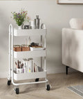 Three Tier Metal Rolling Cart With Wheels, Utility Cart On Casters For Office, Home, Kitchen Or Garden, White Finish, next to sofa