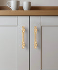 Brushed Brass Cabinet Handles 10 Pack 3 Inch Hole Centers Zinc Gold Drawer Pulls installed on white kitchen cabinet doors