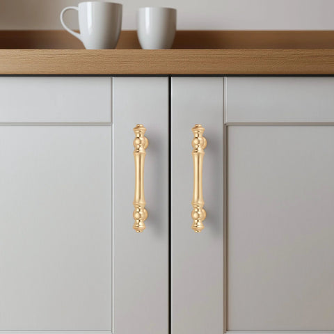 Brushed Brass Cabinet Handles 10 Pack 3 Inch Hole Centers Zinc Gold Drawer Pulls installed on white kitchen cabinet doors