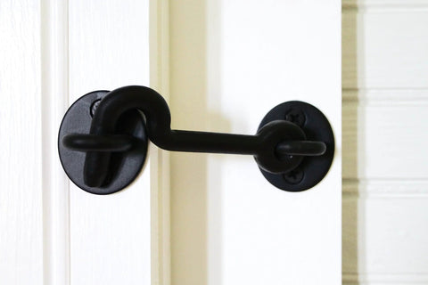 Sliding Door Privacy Hook 4 Inch Matte Black With Mounting Hardware Included Steel Construction Keeps Your Space Private And Quiet No Fuss For Indoor Barn Doors Perfect Accessory For Designer Classic And Builder Kits installed on a white door.