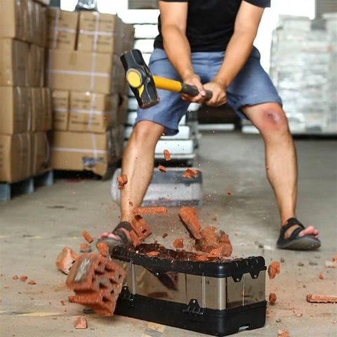 14 Inch And 17 Inch Stainless Steel Tool Box With Removable Tray being tested for durability with a hammer at a job site