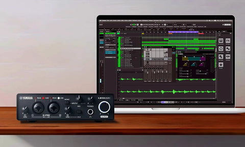2-In 2-Out USB-C Audio MIDI Interface With 32-Bit/192kHz, DSP-Powered Mixing next to laptop displaying audio software