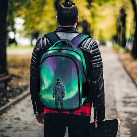 Person wearing Dope Aurora Astronaut Print Unisex Backpack With Large Capacity For Everyday Carry in a park setting