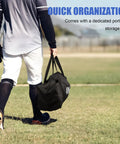 Person carrying 6x6 Foot Baseball Softball Practice Net For Hitting Pitching And Catching With Baseball Tee Includes Bonus Strike Zone Target And Bow Frame Durable Pro Grade 7 Ply Knotless Netting Fiberglass Poles And Ground Stakes storage bag on grass field