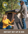 Two people setting up Zeta C6 Pro Six Person Instant Cabin Tent With 60 Second Setup, Rainfly Included, in a park