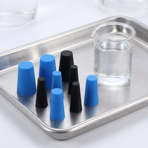 Top Tier Silicone Bottle Stoppers Assortment Kit With 250 High Temp Tapered Plugs For Powder Coating Painting Anodizing And Plating Jobs Ensures No Paint Mist Enters Holes Makes Site Organization A Breeze For Pros Who Need Durable Multi Color Caps. Multi color silicone tapered plugs on metal tray beside glass beaker