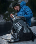 Hiker using G2X Pro Dual Output LED Flashlight With Click Switch Forest Green in outdoor wilderness setting