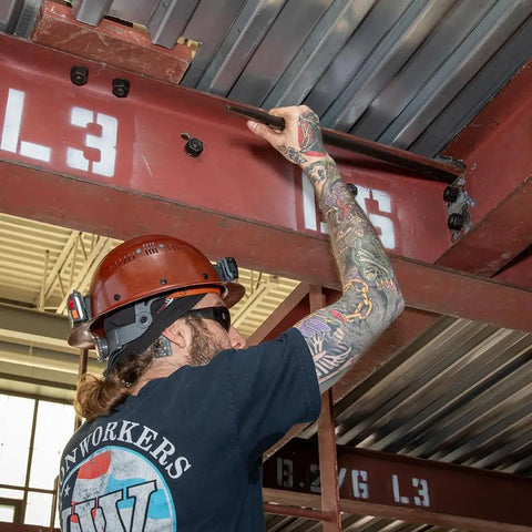 Worker using Made in USA Round 7/8 Inch by 36 Inch Connecting Bar For Solid Aligning Prying And Chiseling Ergonomic Pro Grade Sleever Bar