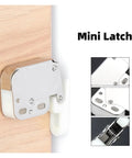Cool Push To Open Touch Latches Make Handleless Cupboards A Breeze Secure Your Kitchen Or Closets Quickly With These Amazing Spring Catch Door Holders No Drilling Needed Super Easy Install For Fast Setup And Reliable Closures That Keep Everything Locked. Mini latch shown on wooden surface, featuring a sleek silver finish and white plastic detail.