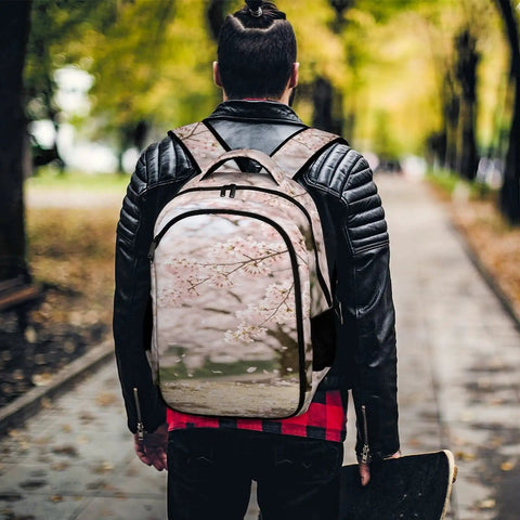 Soft Pink Sakura Spring Scene Printed Unisex Backpack on man in leather jacket walking through park