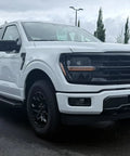 White Ford F-150 truck with Antenna Delete Cap For Ford F-150, SVT Raptor, And F-150 Lightning EV Slick Stock Look installed.